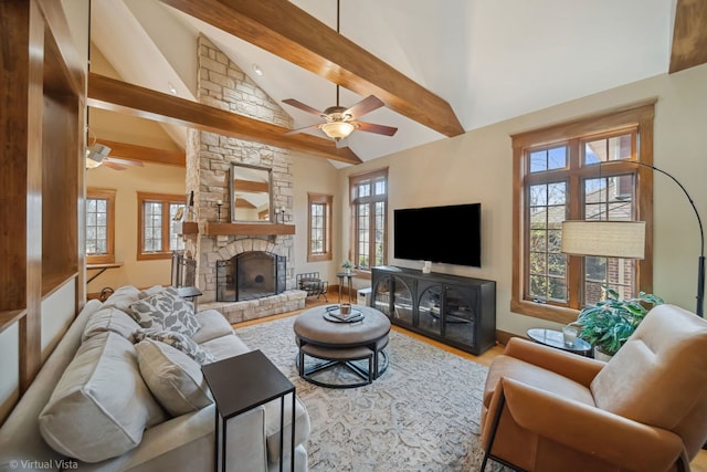 living room featuring a ceiling fan, beam ceiling, and a healthy amount of sunlight