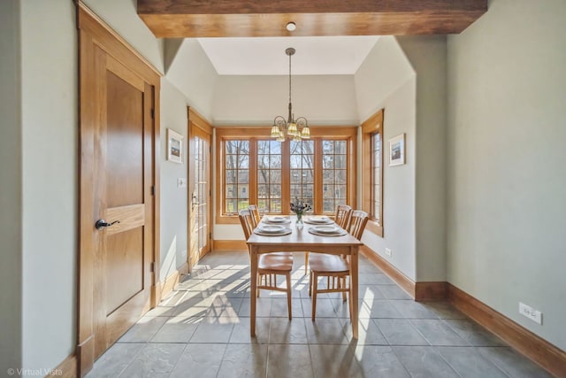 dining room with an inviting chandelier, tile patterned flooring, and baseboards