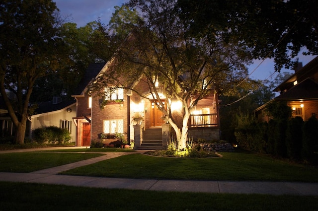 view of front of property featuring a front lawn and stairway