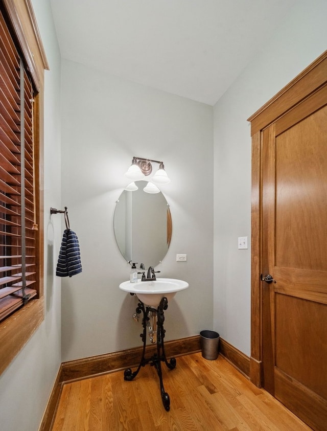 bathroom with baseboards and wood finished floors