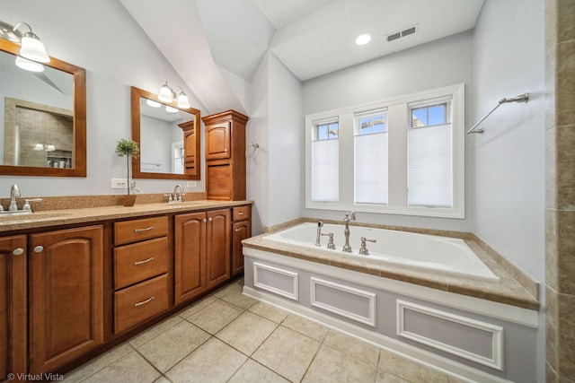 full bathroom with tile patterned flooring, a garden tub, visible vents, and a sink