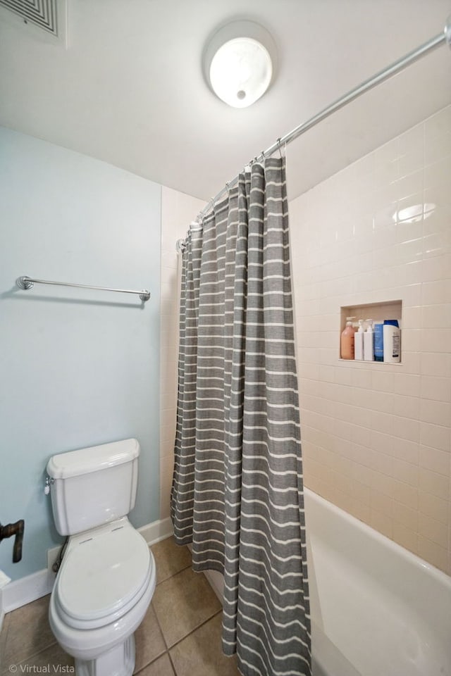 full bath featuring tile patterned floors, baseboards, shower / tub combo, toilet, and visible vents