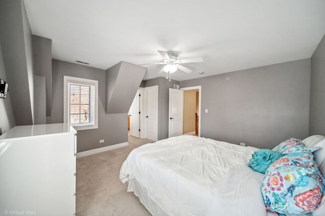 bedroom featuring ceiling fan, light carpet, visible vents, and baseboards