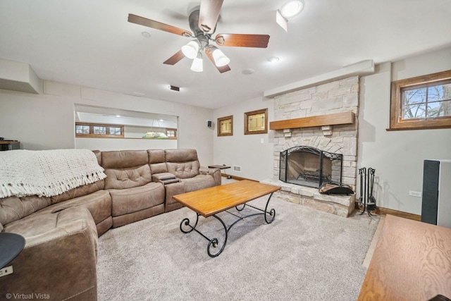 carpeted living room featuring visible vents, a ceiling fan, baseboards, and a fireplace