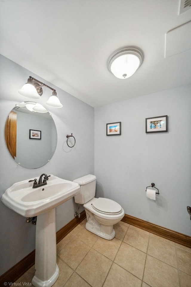 bathroom with baseboards, toilet, tile patterned flooring, and visible vents