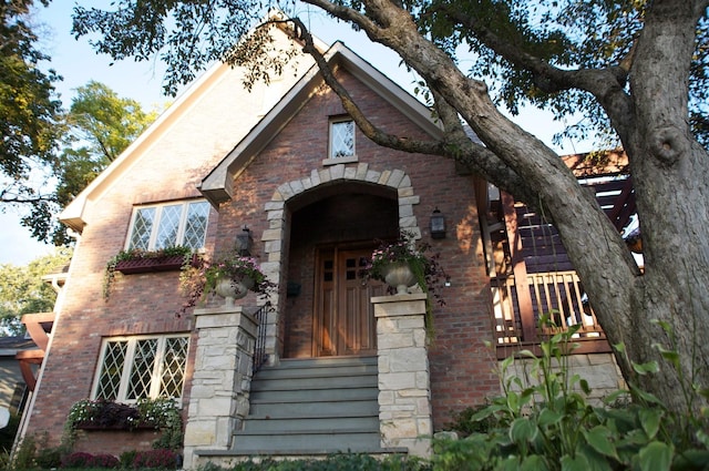 view of exterior entry featuring brick siding