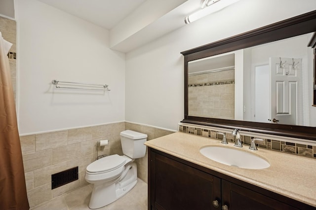 2806 Brindle Ct, Northbrook, IL 60062 - bathroom featuring tile walls, toilet, vanity, a wainscoted wall, and tile patterned floors