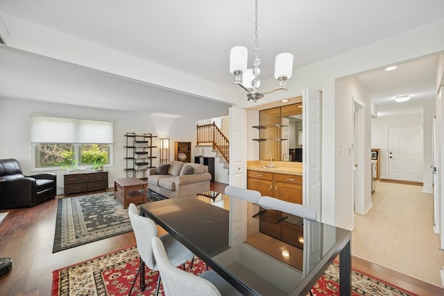 2806 Brindle Ct, Northbrook, IL 60062 - dining area with light wood-style floors, stairs, and a chandelier