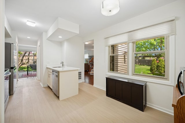 2806 Brindle Ct, Northbrook, IL 60062 - kitchen with appliances with stainless steel finishes, light wood-style floors, light countertops, and baseboards