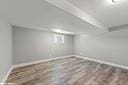 basement with baseboards and wood finished floors