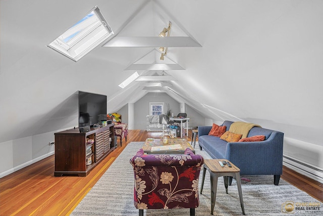 living room featuring wood finished floors and vaulted ceiling with skylight