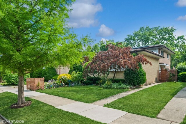 9835 Keeler Ave, Skokie, IL 60076 - view of front of home featuring brick siding and a front lawn
