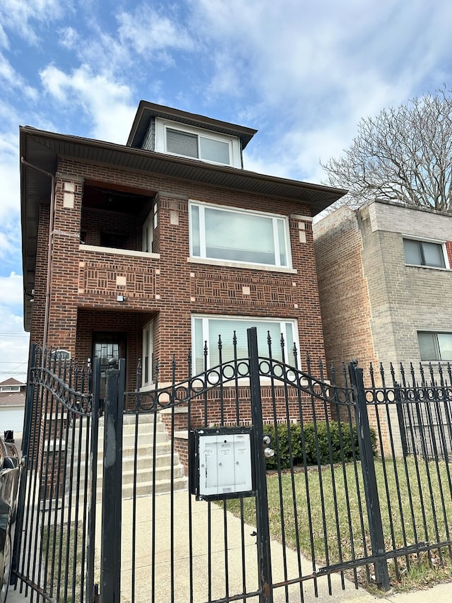 8036 S Yates Blvd, Chicago, IL 60617 - view of front of home featuring a balcony, brick siding, a gate, and a fenced front yard