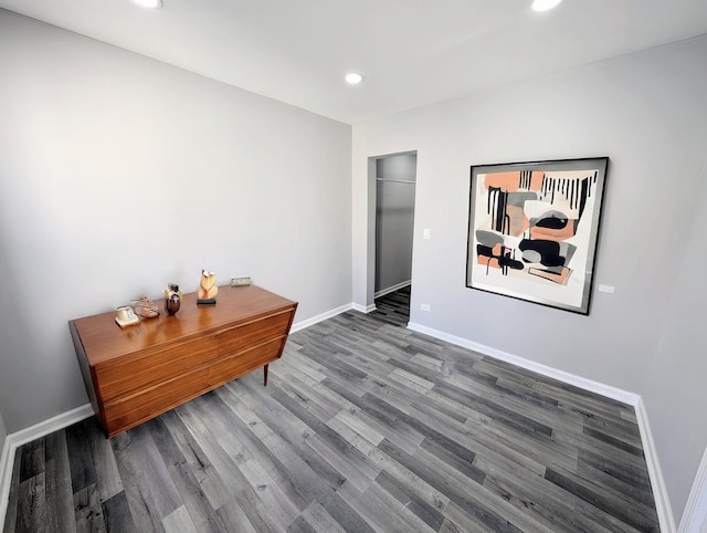 hallway with baseboards and wood finished floors