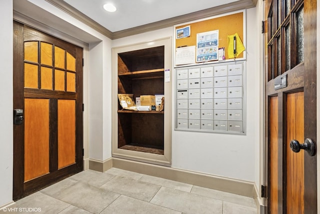 interior space featuring crown molding, mail area, and baseboards