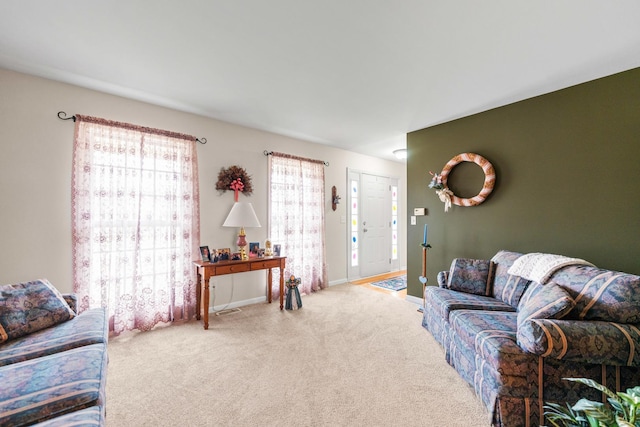 carpeted living room with baseboards