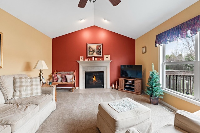 carpeted living room with a fireplace with flush hearth, vaulted ceiling, visible vents, and ceiling fan