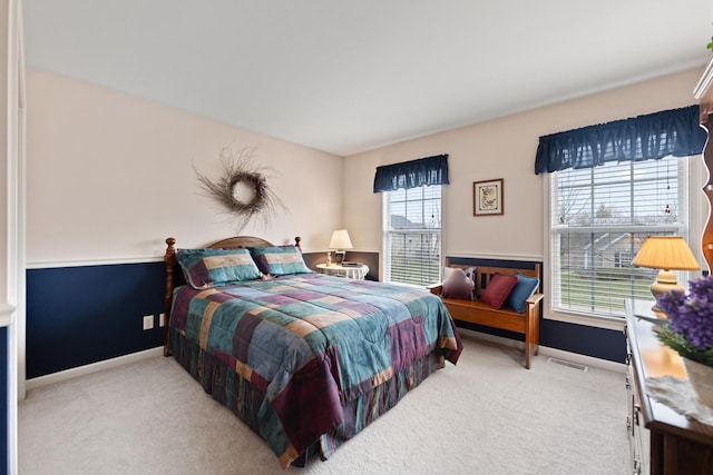 carpeted bedroom with visible vents and baseboards