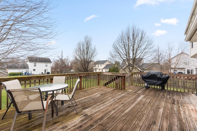 wooden deck featuring area for grilling and outdoor dining area