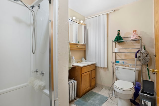 bathroom with radiator heating unit, vanity, tile patterned flooring, toilet, and walk in shower