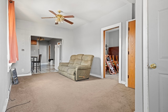 sitting room featuring carpet flooring, baseboards, and a ceiling fan