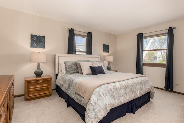bedroom with baseboards and carpet