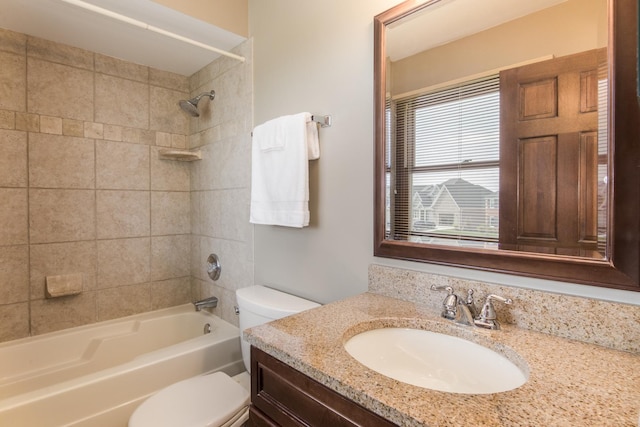 bathroom with vanity, bathtub / shower combination, and toilet