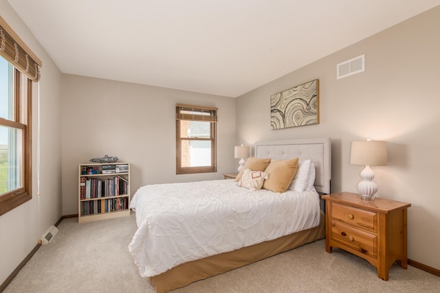bedroom with carpet floors, baseboards, and visible vents