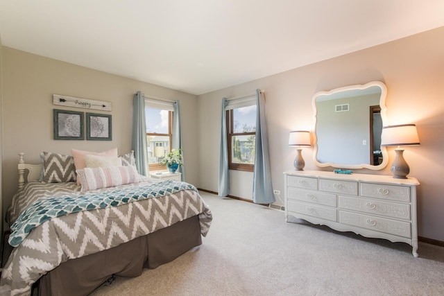 carpeted bedroom with baseboards and visible vents