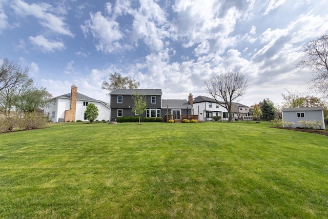 rear view of house featuring a lawn