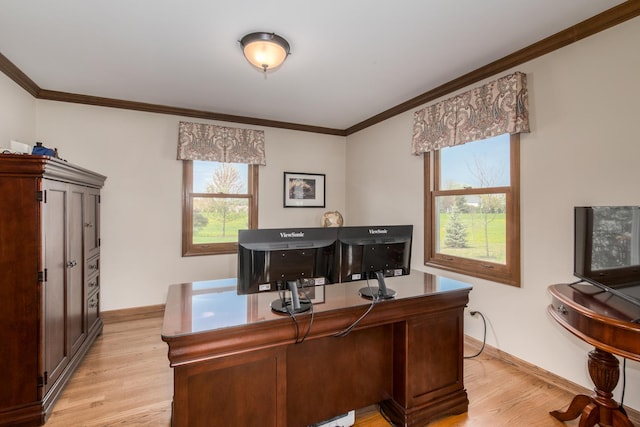 office space with baseboards, ornamental molding, and light wood finished floors