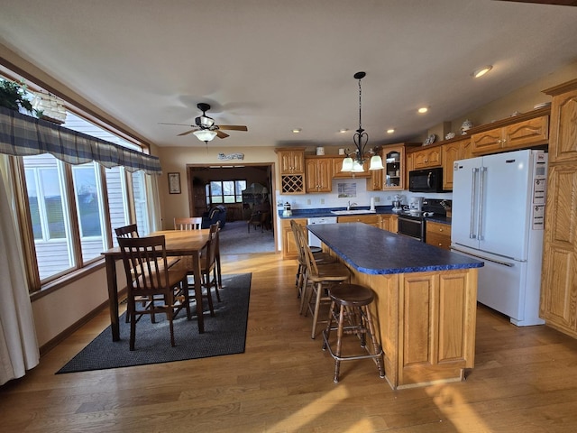 31-3 Lake Carroll Blvd, Lake Carroll, IL 61046 - kitchen with white appliances, glass insert cabinets, a kitchen island, dark countertops, and brown cabinetry