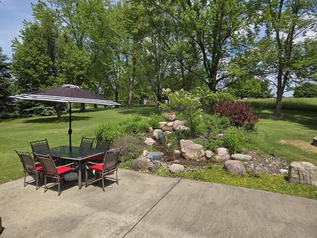 31-3 Lake Carroll Blvd, Lake Carroll, IL 61046 - wooden terrace featuring outdoor dining area, a patio, and a lawn