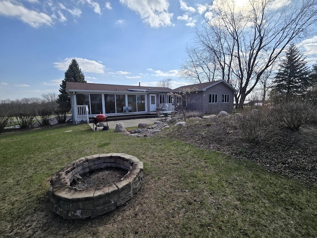31-3 Lake Carroll Blvd, Lake Carroll, IL 61046 - back of house featuring an outdoor fire pit, a sunroom, and a yard