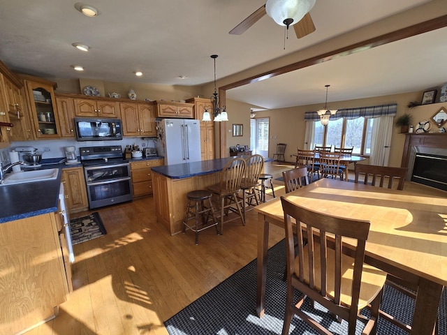 31-3 Lake Carroll Blvd, Lake Carroll, IL 61046 - kitchen with black microwave, range with two ovens, freestanding refrigerator, brown cabinetry, and plenty of natural light