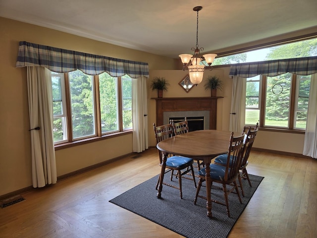 31-3 Lake Carroll Blvd, Lake Carroll, IL 61046 - dining space with a high end fireplace, a chandelier, and light wood-style floors