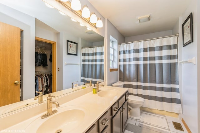 9972 Chetwood Dr, Huntley, IL 60142 - full bathroom with tile patterned flooring, double vanity, toilet, a spacious closet, and a shower with shower curtain
