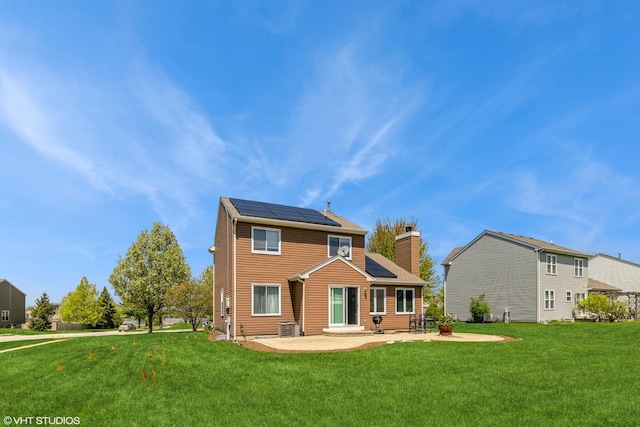 9972 Chetwood Dr, Huntley, IL 60142 - rear view of property with solar panels, a patio, a yard, and a chimney