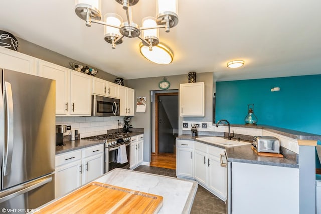 9972 Chetwood Dr, Huntley, IL 60142 - kitchen with appliances with stainless steel finishes, a sink, a chandelier, and white cabinetry