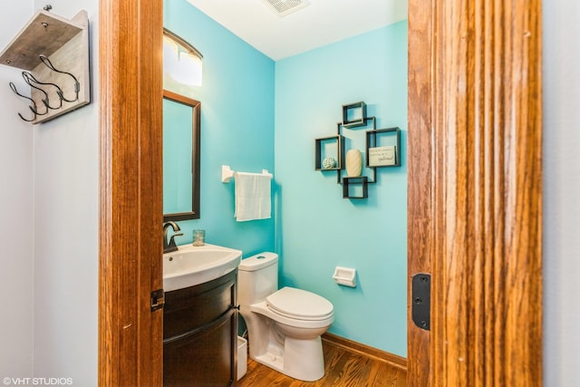 9972 Chetwood Dr, Huntley, IL 60142 - half bathroom with toilet, wood finished floors, vanity, and baseboards