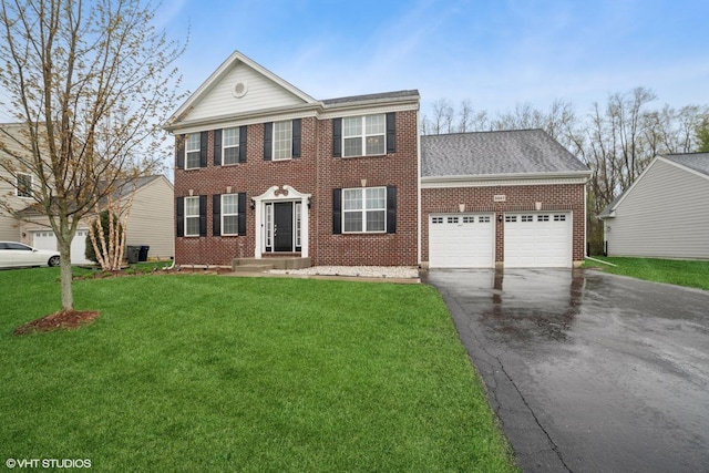 neoclassical home featuring brick siding, aphalt driveway, a front lawn, and an attached garage