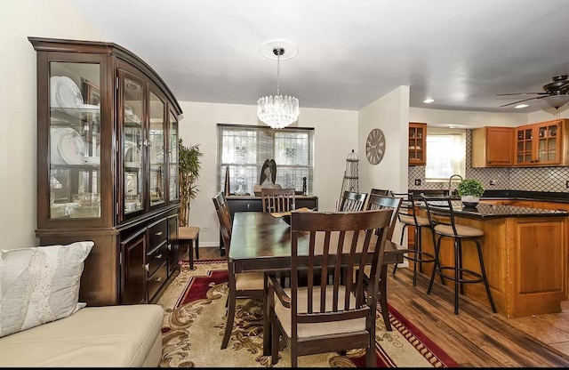 dining area with a chandelier, dark wood-style floors, and recessed lighting