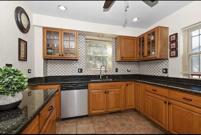 kitchen featuring a ceiling fan, brown cabinets, decorative backsplash, dishwasher, and a sink