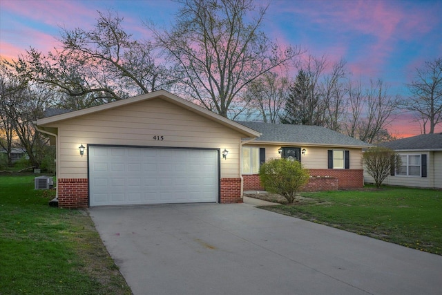 415 E 14th St, Gibson City, IL 60936 - single story home featuring a front lawn, cooling unit, driveway, brick siding, and a garage