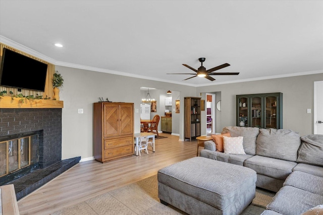 415 E 14th St, Gibson City, IL 60936 - living area with light wood-style floors, crown molding, baseboards, a fireplace, and ceiling fan with notable chandelier
