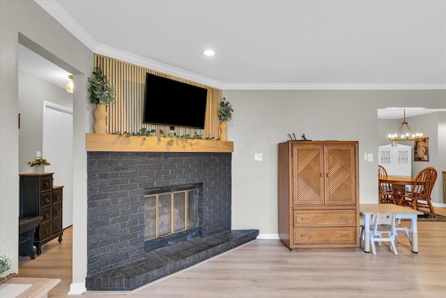 415 E 14th St, Gibson City, IL 60936 - living room with an inviting chandelier, ornamental molding, a brick fireplace, and wood finished floors