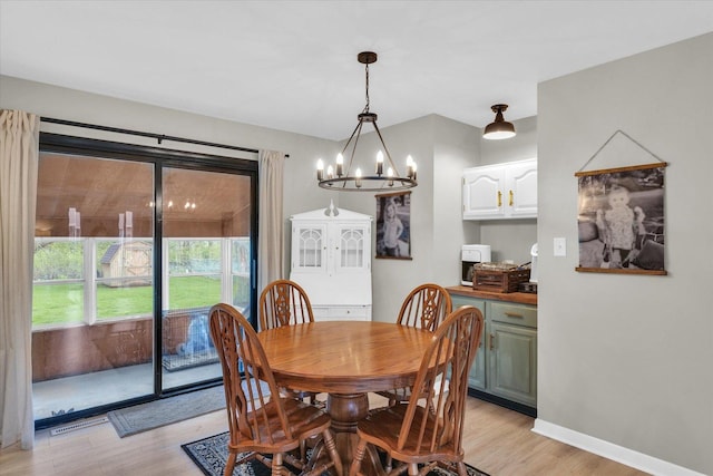 415 E 14th St, Gibson City, IL 60936 - dining area featuring baseboards, an inviting chandelier, visible vents, and light wood-style flooring