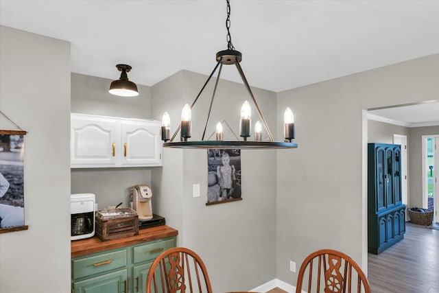 415 E 14th St, Gibson City, IL 60936 - interior space featuring baseboards, wood finished floors, and a chandelier