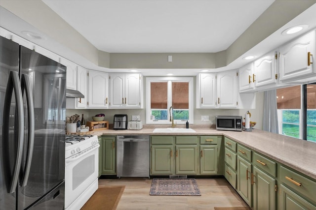 415 E 14th St, Gibson City, IL 60936 - kitchen featuring white cabinetry, green cabinetry, a sink, and appliances with stainless steel finishes