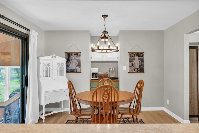 415 E 14th St, Gibson City, IL 60936 - dining room with a chandelier, light wood-style flooring, and baseboards